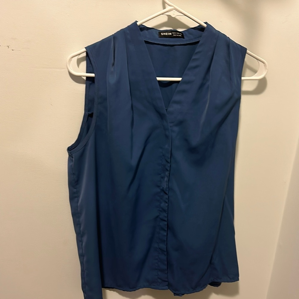 Blue button-down, v-neck blouse.